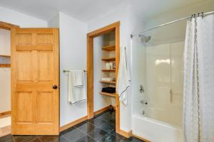 a bathroom with a shower and a wooden door at Fish, Hike and Ski Spacious Family Escape in Eden in Eden +16 photos