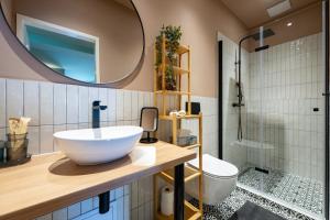 a bathroom with a sink and a toilet and a mirror at Budapest Central Sky Spa Penthouse in Budapest +28 photos