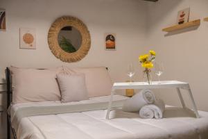 a bedroom with a bed with a table and a mirror at Old San Juan Apartment in San Juan