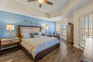 a bedroom with a bed and a ceiling fan at Villas of Ocean Gate II 306 in Butler Beach +20 photos