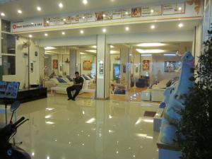 a man sitting on a couch in a store lobby at Atlantis Condo Resort by Anatolii in Jomtien Beach +83 photos