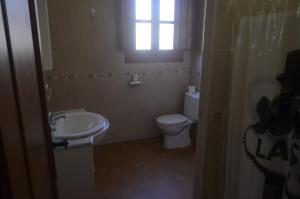 Un baño con inodoro, lavabo y ventana. en Pinar Hermoso, en Bullas