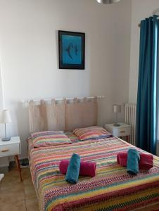 a bed with two pillows on it in a bedroom at Le Fontana in Nice