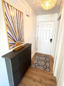 a hallway with a dresser and a door with a painting at 2109 Landfall Way in Seabrook Island