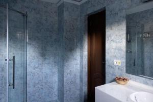 a bathroom with a glass shower and a sink at Pension Tui in Sinaia +94 photos