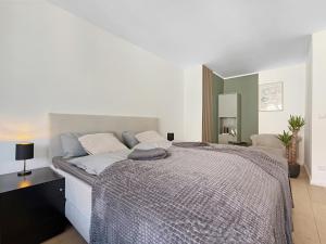 a bedroom with a large bed with a large mirror at Heart of Hannover Apartment in Hannover +3 photos