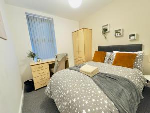 a bedroom with a bed and a dresser and a window at Room 2 Shared House in L7 in Liverpool