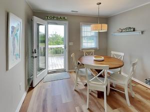 a dining room with a table and chairs at The Sassy Sea Turtle in Hampstead +23 photos