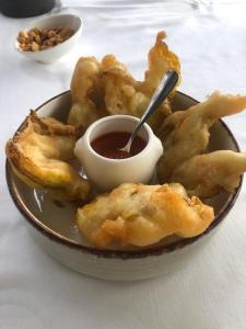 a bowl of fried food with a dipping sauce at Le Fontana in Nice