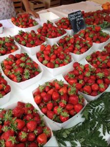 a display of strawberries in white bowls on a table at Le Fontana in Nice