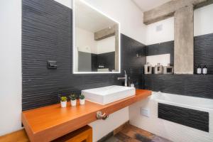 a bathroom with a sink and a mirror at Oakmoon House in Faro +55 photos