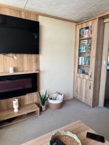 a living room with a flat screen tv and a couch at Lodge in Forfar, Angus, relax in comfort in Angus