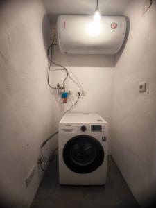a washing machine in a bathroom with a light at Beautiful mountain chalet in Siete Aguas