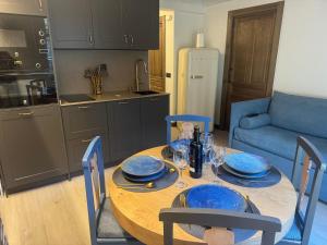a kitchen with a wooden table with blue plates on it at Casa Rural Garabitero in Laguardia +31 photos