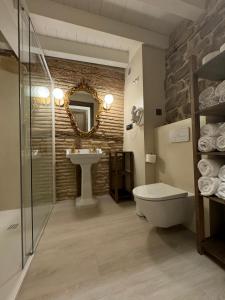 a bathroom with a sink and a toilet and a mirror at Casa Rural Garabitero in Laguardia