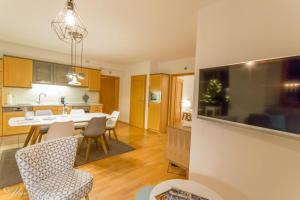 a kitchen and living room with a table and chairs at Ferienwohnung Maierers Schaiere in Gammesfeld +22 photos