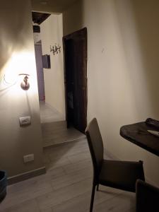 a room with a table and a chair and a door at Casa D'amore in Riomaggiore