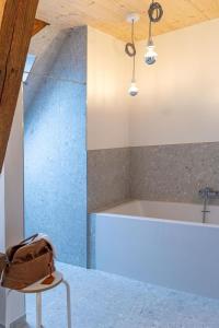 a bag sitting on a stool in a kitchen with a sink at Landurlaub mit neugierigen Blicken in den Pferdestall, eingezäuntem Garten, Kamin und Sauna in Rot am See +52 photos