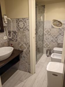 a bathroom with a sink and a toilet and a shower at Casa D'amore in Riomaggiore