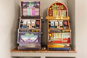 three slot machines sitting on top of a shelf at Dale in Scottsdale