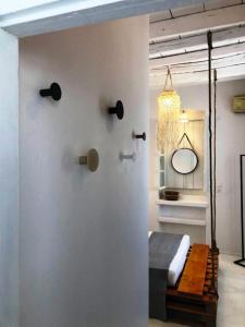 a bedroom with a bed and a mirror on the wall at Milos Heritage Home 1883 in Adamantas +5 photos