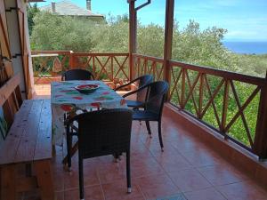 a table and chairs on the balcony of a house at Villa Foti in Astris