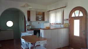a kitchen with a table and a table and a door at Villa Foti in Astris