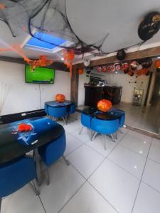 a dining room with blue tables and orange decorations at Hotel Zafiro Boutique in Bogotá