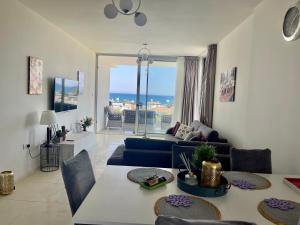 a living room with a couch and a table at Sea Breeze Suites by the Coast in Iskele