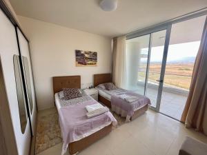a bedroom with two beds and a large window at Sea Breeze Suite by the Sea in Vokolidha +13 photos