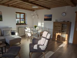 a living room with a table and a dining room at "BayernWald 201" Ferienwohnung mit Pool und Sauna in Hauzenberg