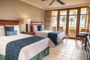 a hotel room with two beds and a balcony at Pierre Mundo Imperial Riviera Diamante Acapulco All Inclusive in Acapulco