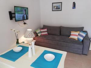 a living room with a couch and a table at Apartman Olly in Klek
