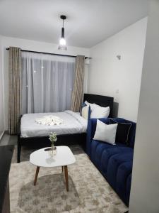 a living room with a couch and a bed at Comfort and charm in Nairobi
