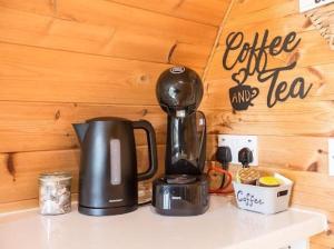 a coffee maker sitting on top of a counter at The Hideaway Glamping Pod 2 With Hot Tub & Cold Shower in Naas +13 photos