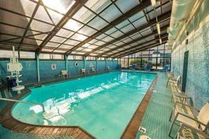 a large indoor swimming pool with a ceiling at Barclay Towers Resort in Virginia Beach