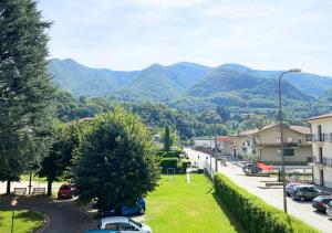 a street in a town with mountains in the background at Wifi & Free Park BGY Airport 20 min in Zogno