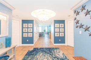 a hallway with blue walls and stars on the wall at Oceanfront Tower 3 Gulf & Bay View 3-Bedroom 18th Floor Condo in Pensacola Beach in Pensacola Beach