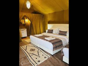 a bedroom with a large bed in a room at Merzouga Desert Camp in Merzouga