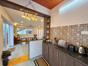 a kitchen with a counter and a dining room at Ta Cabana Beach house-Pondicherry in Pondicherry