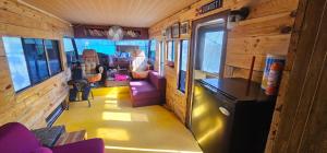 an inside view of a train room with purple furniture at MejorClub in Valle de Anton