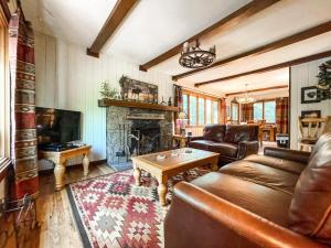 a living room with a couch and a fireplace at Mountainside Cabin_peaceful_near hiking trails in Chipita Park