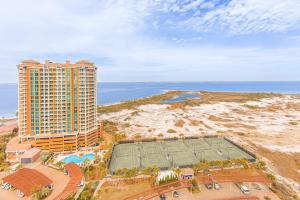 an aerial view of a building and a tennis court at Oceanfront Tower 3 Gulf & Bay View 3-Bedroom 18th Floor Condo in Pensacola Beach in Pensacola Beach