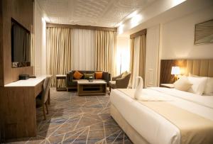 Postel nebo postele na pokoji v ubytování Nars Plus Al Naeem Hotel