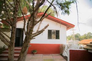 a white and red house with a red roof at Casa rustica MZTLA in Mazamitla