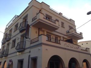 a large building with balconies and a sign on it at Hotel C'era Una Volta in Castiglione della Pescaia