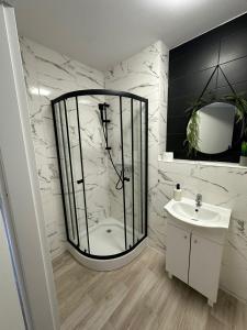 a bathroom with a glass shower and a sink at Hostel J17 in Katowice +99 photos