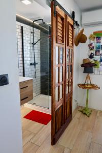 a bathroom with a shower and a glass door at Appartement design & confort- Route des hôtels in Le Gosier