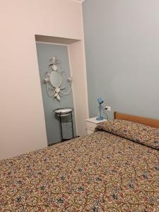 a bedroom with a bed and a mirror on the wall at casa Marino in Tuoro sul Trasimeno