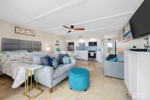 a living room with a couch and a bed and a kitchen at Spectacular Ocean View STEPS from the Beach and Pool! Third Floor Studio! in Edgewater